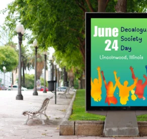 Street billboard displaying a colorful poster for Decalogue Society Day on June 24 in Lincolnwood, Illinois, featuring silhouettes of cheering people in vibrant colors.