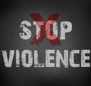 Grungy textured graphic with the words 'STOP VIOLENCE' and a large red 'X' overlaying the word 'STOP', symbolizing a strong anti-violence message.