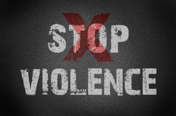 Decalogue Condemns Hate Crimes Against Any Individuals 1 Grungy textured graphic with the words 'STOP VIOLENCE' and a large red 'X' overlaying the word 'STOP', symbolizing a strong anti-violence message.